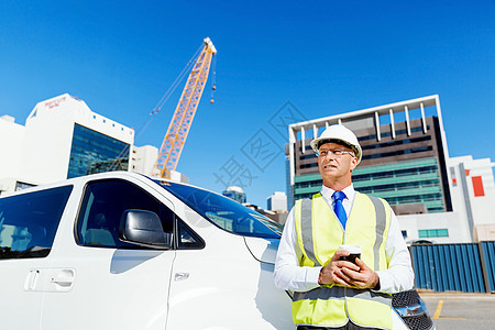 建筑工地的工程师建设者建筑工程师施工场景穿着安全背心咖啡图片