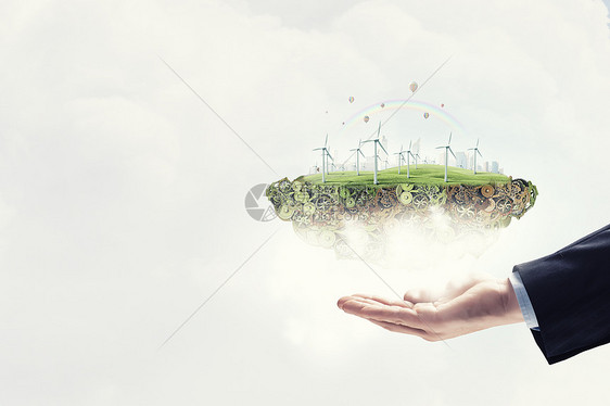 替代能源双手着生态与风车发电机图片