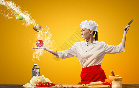 带刀的亚洲女厨师亚洲女厨师用刀子空气中切割水果蔬菜图片
