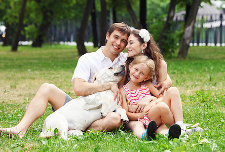 快乐的家庭户外玩得开心夏天公园里的轻家庭只狗户外图片