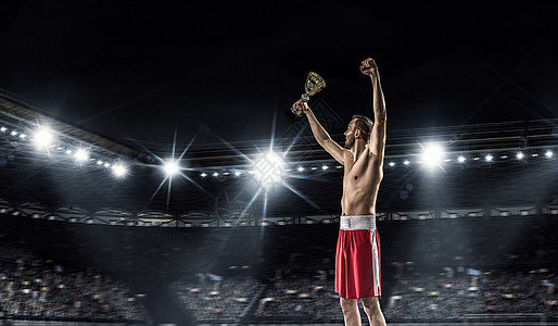 专业拳击冠职业拳击手舞台上的聚光灯庆祝胜利图片