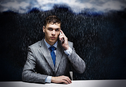 生意上的麻烦轻的麻烦商人坐雨下打电话图片