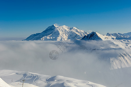 高山冬山景观低云阳光明媚的日子里,法国阿尔卑斯山上覆盖着雪瓦尔迪塞尔,法国图片