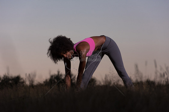 轻健康的黑人妇女正伸展运动,放松热身后,慢跑跑步大自然美丽的夏天晚上图片