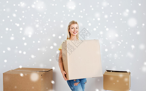 搬家,送货,住房,住宿人的微笑的轻妇女,家里的纸板箱雪地上图片