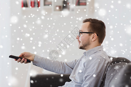 人,技术娱乐活动的微笑的人戴着眼镜,家里电视遥控器雪地上图片