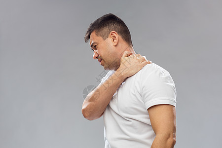 人,医疗保健问题幸的人遭受颈部疼痛的灰色背景图片