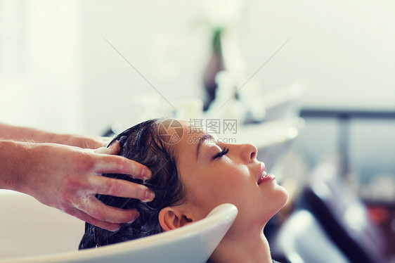 美容人的快乐的轻女人与理发师美发厅洗头美发沙龙快乐的轻女人图片