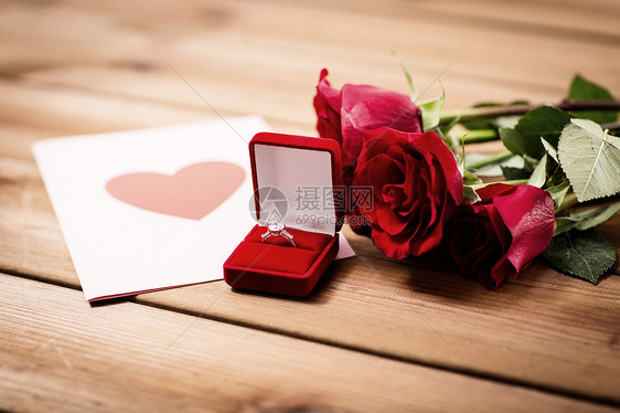 爱情,求婚,情人节假日礼品盒与钻石订婚戒指,红玫瑰贺卡上的木材复古效果图片