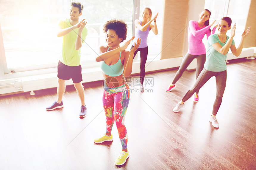 健身,运动,舞蹈生活方式的群微笑的人与教练健身房工作室跳舞图片