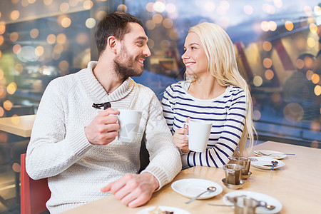 人,休闲,沟通,饮食快乐的夫妇会议咖啡馆喝茶假日灯光背景图片