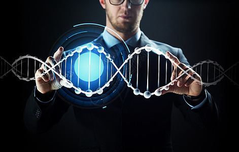 商业,人,技术网络的密切的商人与虚拟现实屏幕DNA分子投影黑色背景用虚拟DNA分子接近商人图片