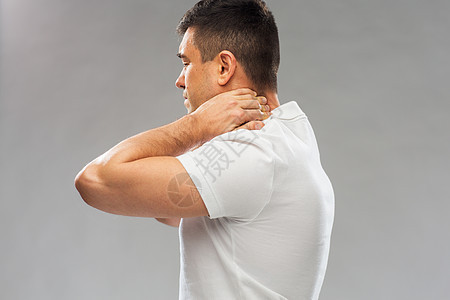 人,医疗保健问题密切的人遭受颈部疼痛的灰色背景靠近患颈部疼痛的人图片