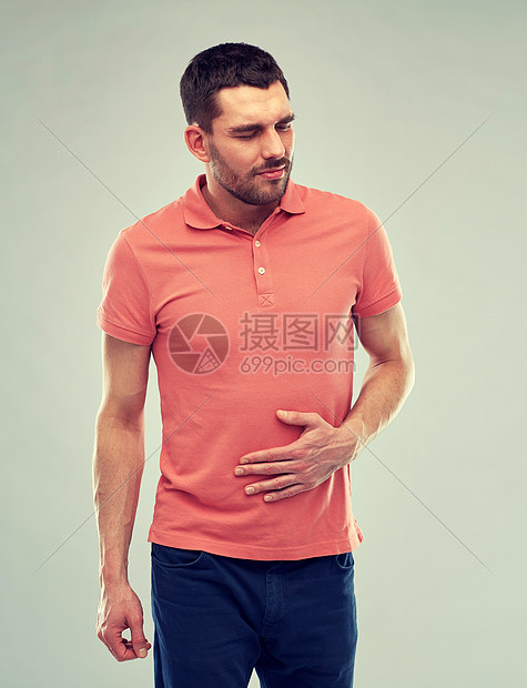 人,医疗保健问题幸的人患胃痛的灰色背景幸的人胃痛图片