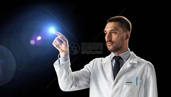 科学,未来技术人的医生科学家穿着白色外套,黑色背景上光穿着白色外套的医生科学家图片