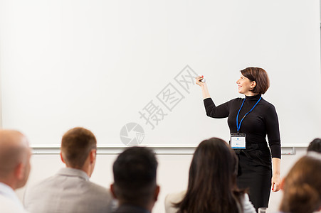 商业,教育人的微笑的女商人教师与远程群学生会议演示讲座出席商务会议讲座的群人图片