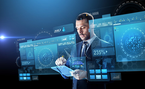 商业,人未来的技术商人西装与透明平板电脑虚拟屏幕投影黑色背景商人穿着透明平板电脑图片