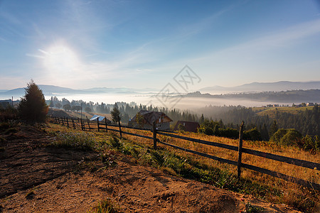 喀尔巴阡山脉阳光明媚雾蒙蒙的早晨雾蒙蒙的山丘上的村庄图片