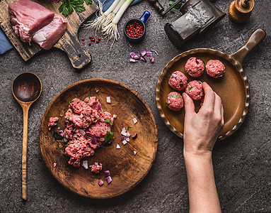 肉丸的制作女手把肉球放煎锅里厨房桌子上准备肉,强制肉,绞肉机勺子,顶部视图烹饪,食谱饮食图片