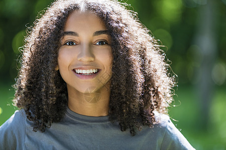 户外肖像美丽的快乐混合种族非裔美国女孩十几岁的女轻女子微笑与完美的牙齿图片