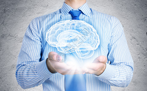 医学创新特写商人手中握着大脑的形象图片