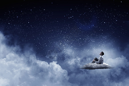 夜空中的商人穿着西装的商人孤立地坐云上看着月亮图片