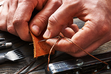 用手工工具与皮革工作的人图片