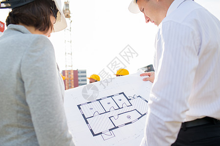 建筑,商业,队合作人的密切建筑师与蓝图建筑场景图片