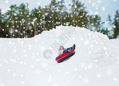 冬天,休闲,运动,人的快乐的十几岁的女孩女人滑下雪管图片
