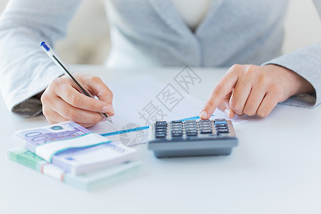 商业金融税收人民用计算器税务报表密切妇女的手数欧元货币背景图片