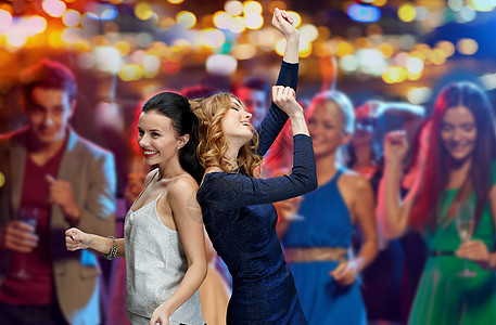 聚会快乐的人们在夜总会迪斯科跳舞的夜灯背景背景