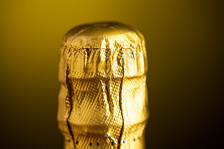 饮料,酒精,包装假日香槟瓶软木塞顶部包裹黑暗背景下的箔背景图片