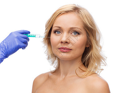 美容,抗衰容手术的女部美容师手配合注射器注射脸颊图片