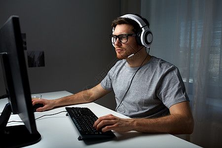 技术,游戏,娱乐活动,让39的游戏人的轻人耳机眼镜与个人电脑玩游戏家里流媒体播放演练视频图片
