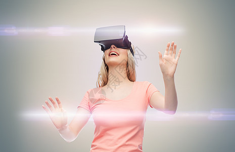 技术,虚拟现实,娱乐活动人的快乐的轻妇女与虚拟现实耳机3D眼镜灰色背景激光图片