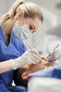 人,医学,口腔医学保健女牙医与牙科镜探头检查男病人牙齿牙科诊所办公室图片