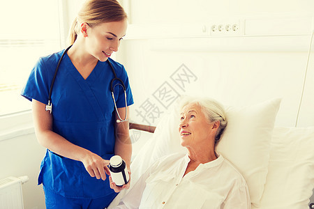 医学,龄,保健人的医生护士向医院病房的老年女子展示药物图片
