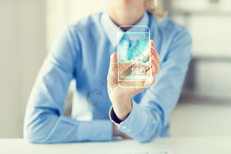 商业,技术人的密切的女手握透明的智能手机办公室图片
