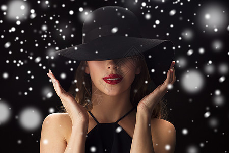 人们,诞节,假日,奢侈时尚美丽的女人戴着黑色背景雪的帽子图片