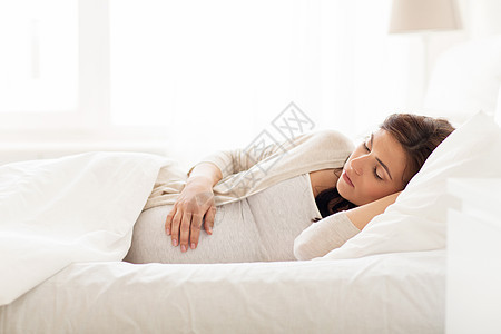 怀孕,休息,人期望的快乐的孕妇睡家里的床上背景图片