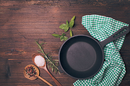 新鲜罗勒迷迭香,海盐干胡椒煎锅附近的木制勺子图片