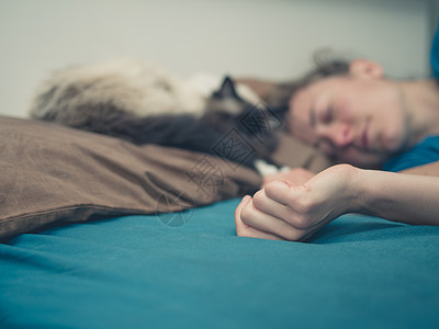 个轻的女人睡张床上,旁边只猫图片