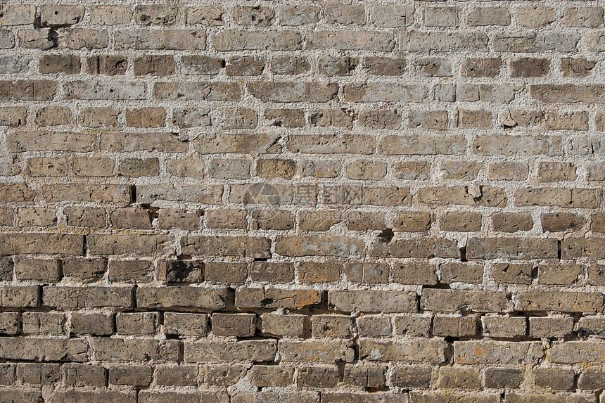 旧砖墙,磨损的石头深色图片