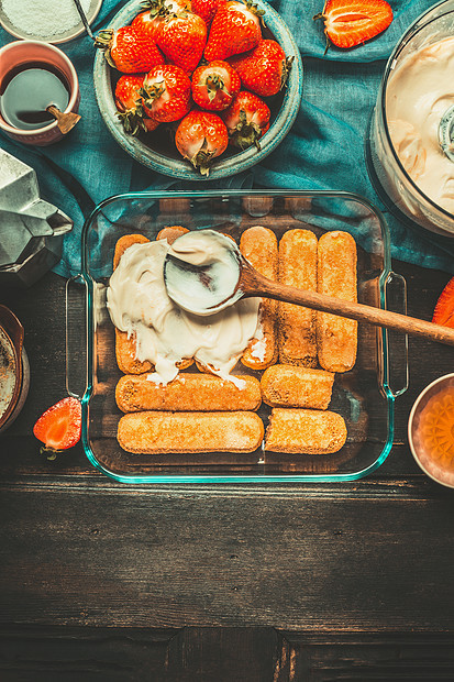 草莓提拉米苏制作菜与饼干,奶油勺子乡村厨房桌子上与提拉米苏烹饪配料,顶部视图,文字的地方意大利食品图片
