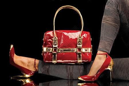 个别致的红色手提包的特写,还感的女腿,穿着优雅的红色鞋子图片
