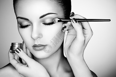 化妆师应用眼影漂亮的女人脸完美的妆容黑白相间图片