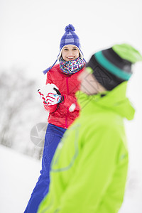 微笑的轻女人男朋友打雪仗图片