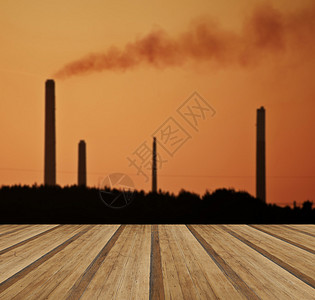 工业烟囱堆叠污染空气个自然景观与木制木板地板图片