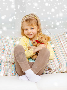 童,人,假日幸福的微笑的小女孩泰迪熊坐家里的沙发上图片