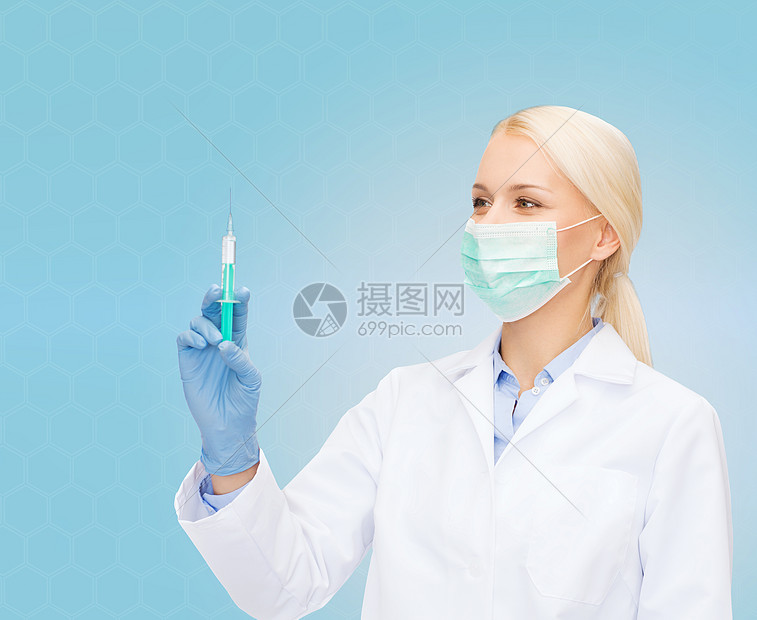 医疗保健医学戴口罩手套的女医生着蓝色背景的注射器图片